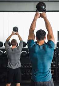 a group of people lifting weights in a gym