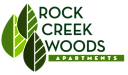 The image is a logo for Rock Creek Woods Apartments.
