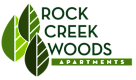 The image is a logo for Rock Creek Woods Apartments.