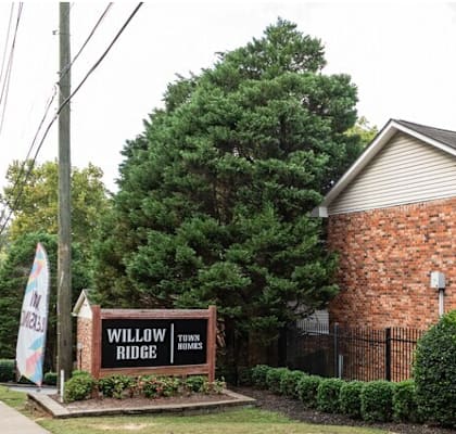 A brick apartment building with a sign that says "Windsor Apartments".