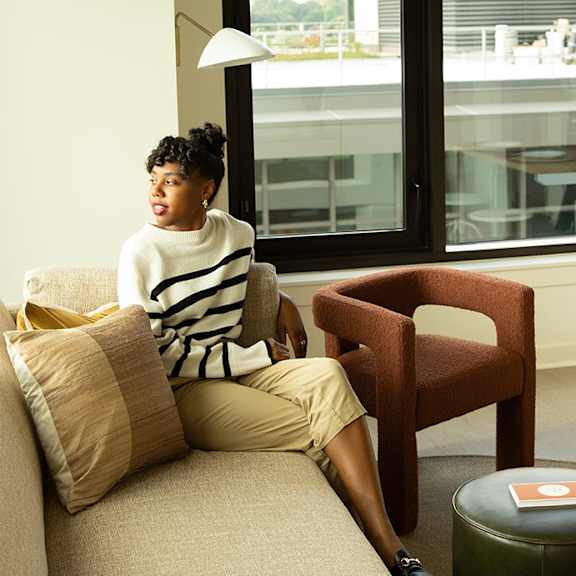 Woman sitting on couch1 at Scout Living, powered by Placemakr, Atlanta