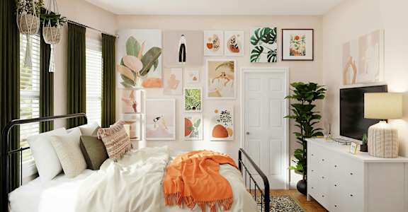 a bedroom with a bed and pictures on the wall