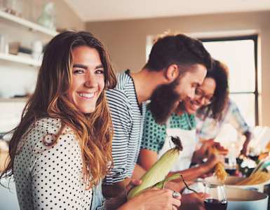 a group of people in a kitchen preparing food