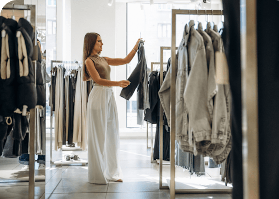A woman is shopping for clothes in a store.