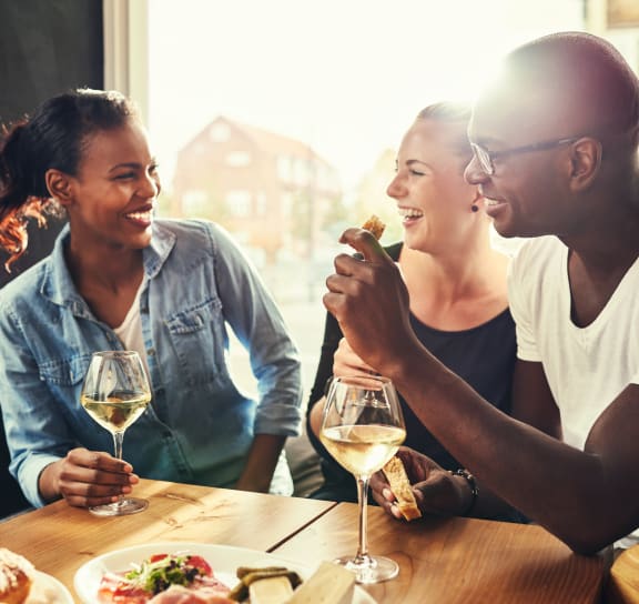 a group of people sitting at a table with food and wine  at The Griffin Royal Oak, Royal Oak, Michigan