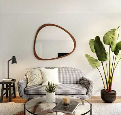 a living room with a couch and a mirror on the wall