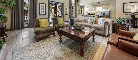 A living room with a brown leather couch and a coffee table.