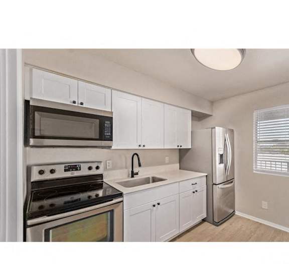 a kitchen with a stove microwave and refrigerator