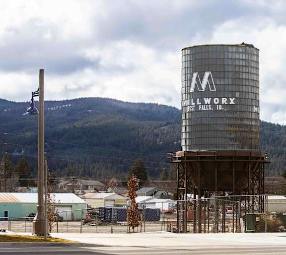 A large Millworx silo stands next to a building.