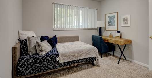 a bedroom with a bed and a desk and a window at Oaks at Oxon Hill, Oxon Hill, Maryland