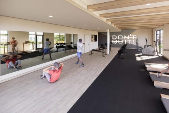 A gym with people working out and a motivational sign on the wall.