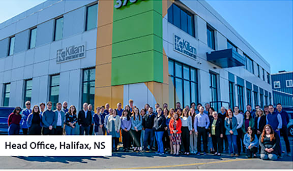 A group of people standing in front of the Killam corproate head office building