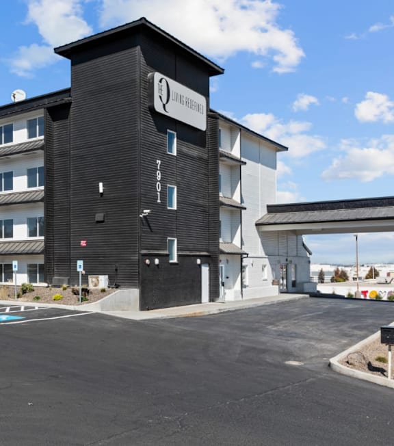 A black building with a white sign that says "Living Bridge".