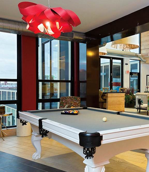 a pool table in a living room with a fireplace
