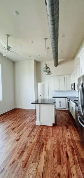 a kitchen with a center island next to a stove top oven