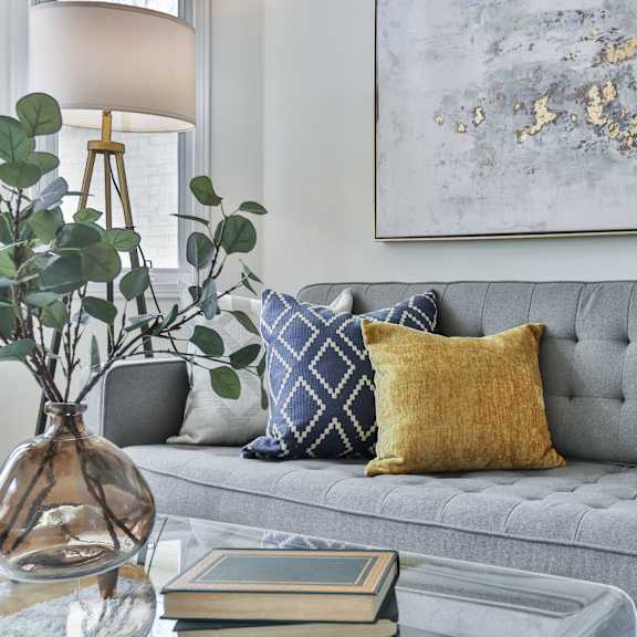 couch with blue and gold pillows