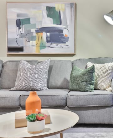 a living room with a gray couch and a coffee table