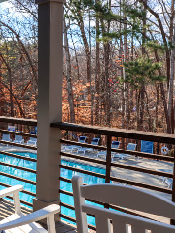 rocking chairs on the deck overlooking the pool