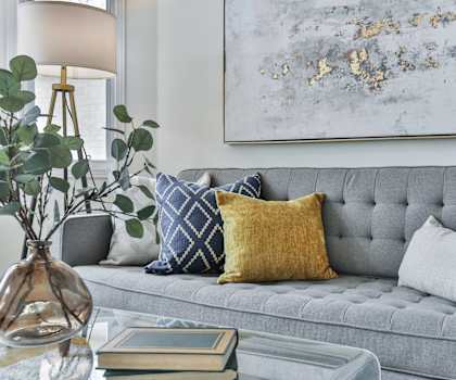 a living room with a gray couch and pillows