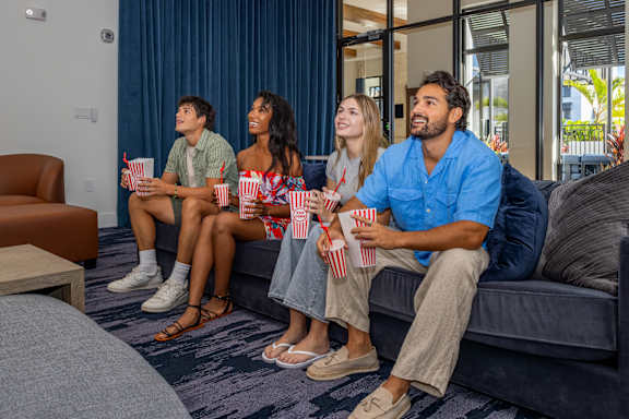 Group of people eating pop corn and watching television at Portofino Vineyards, Fort Myers, FL, 33967