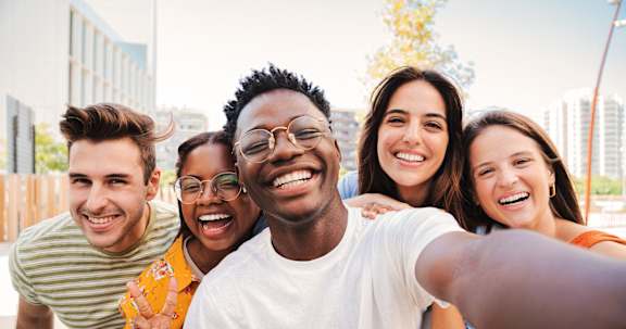 A group of friends taking a selfie together at Heights at Black Bear Apartments, Morgantown, WV
