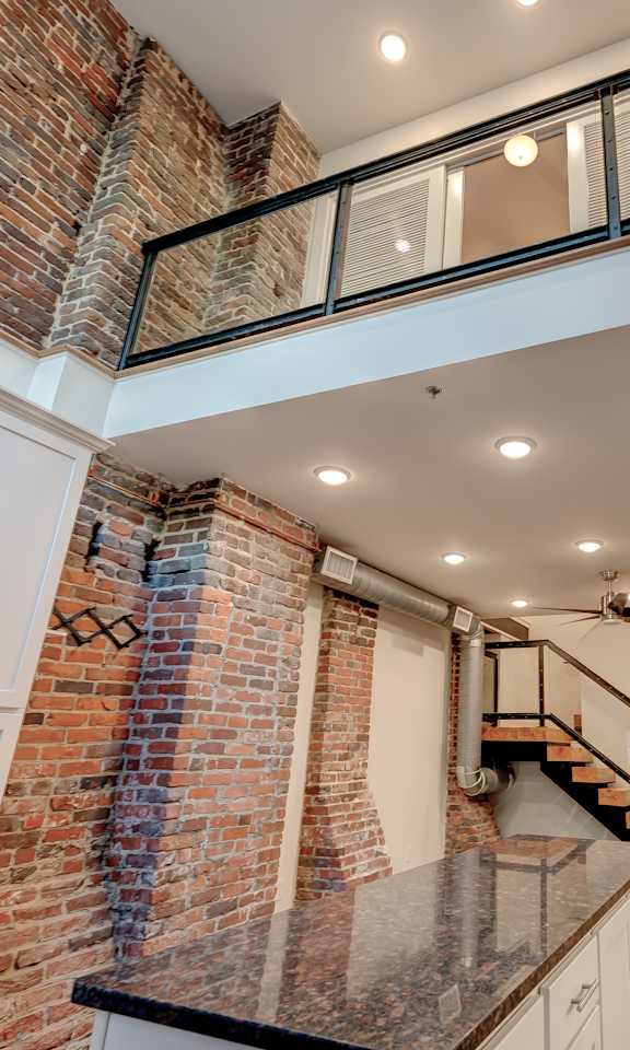 A kitchen with a staircase leading to the upper floor.