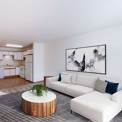 a living room with a white couch and a table. Fargo, ND Lake Crest Apartments