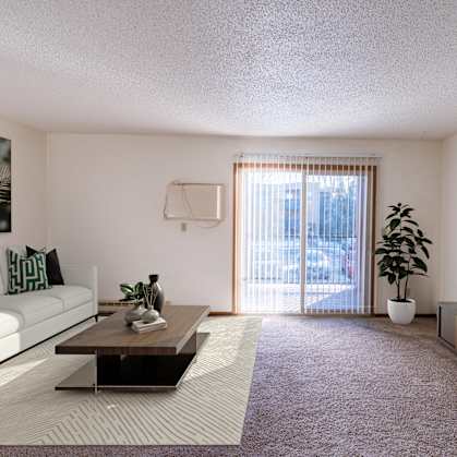 a living room with a couch and a coffee table and a television. Grand Forks, ND Cedarwood Apartments