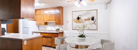 A kitchen with a table and chairs. Fargo, ND Park Terrace Apartments