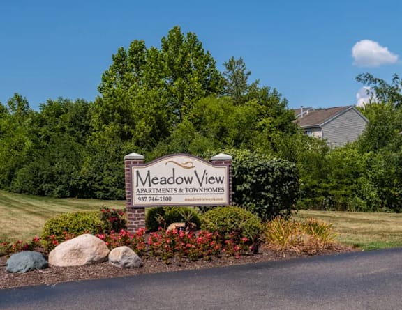 the sign at the entrance to bath farms with flowers