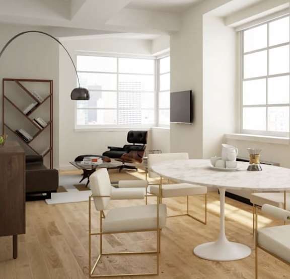 A modern dining room with a white marble table and gold chairs.at 21 West, New York