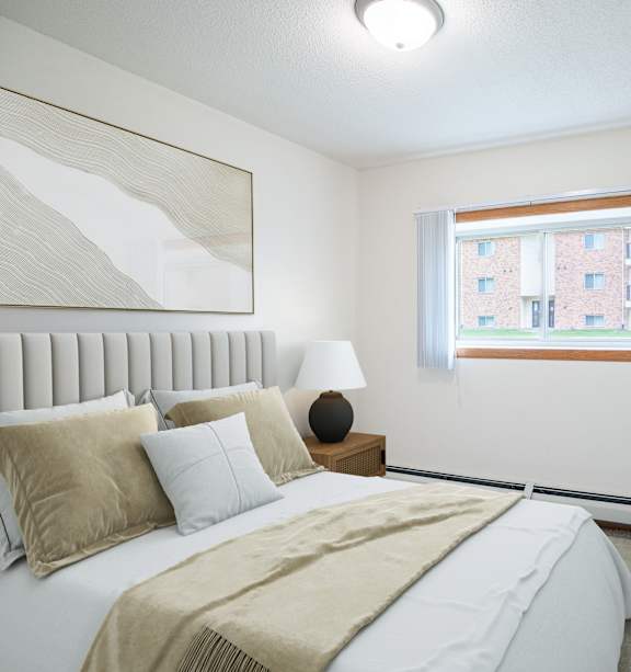 Bismarck, ND Stonefield Townhomes | Dining Room A bedroom with a large bed and a window. Grand Forks, ND Columbia West Apartments