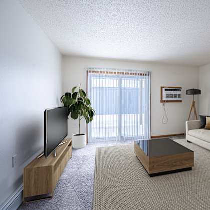 A living room with a couch, a coffee table, and a television. Moorhead, MN Woodstone Apartments