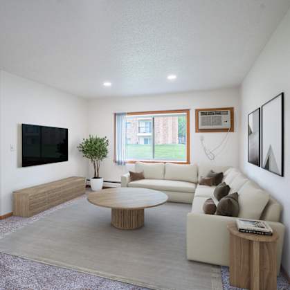 A living room with a couch, a coffee table, and a television. Grand Forks, ND Columbia West Apartments