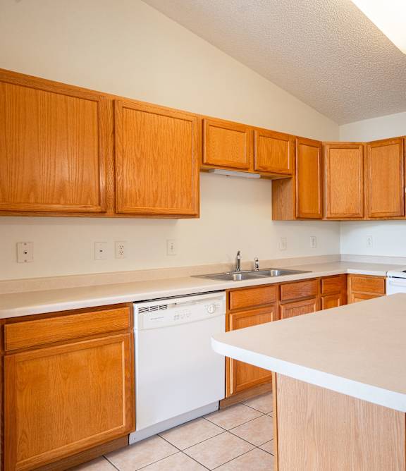 Bismarck, ND Sierra Ridge |a kitchen with white appliances and wooden cabinets