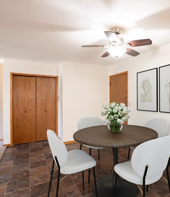a dining room with a table and chairs