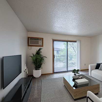 a living room with a white couch and a television