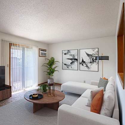 a living room with white furniture and a television. Fargo, ND Southview Village Apartments