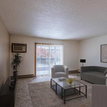 an apartment living room with a couch and a coffee table. Fargo, ND West Oak Apartments