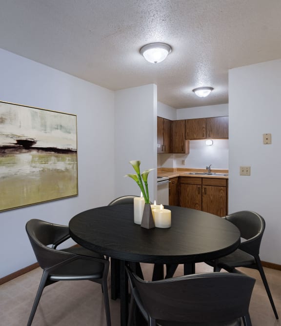 a dining room with a table and chairs and a kitchen
