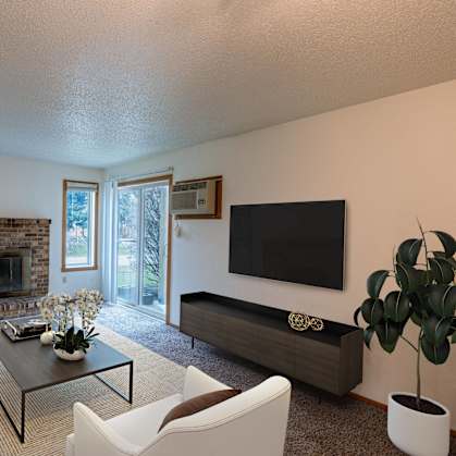 a living room with a couch and a tv and a fireplace. Fargo, ND Galleria 3 Apartments