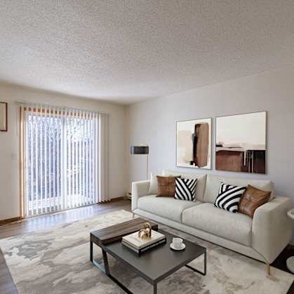 a living room with a couch and a coffee table. Fargo, ND Village West Apartments