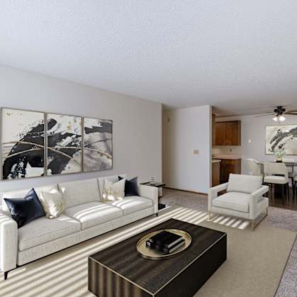 a living room with a couch and a coffee table and a dining room. Fargo, ND Windsor Apartments