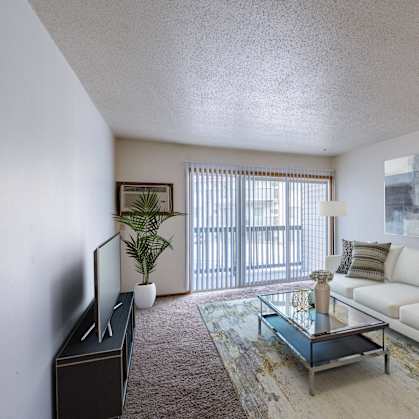 a living room with a couch and a coffee table. Moorhead, MN South Park Apartments