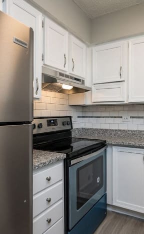 a kitchen with stainless steel appliances and white cabinets at Willow Bend Apartments, Durham, NC, 27707