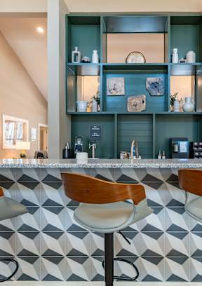 A modern kitchen with a large island and wooden floors.
