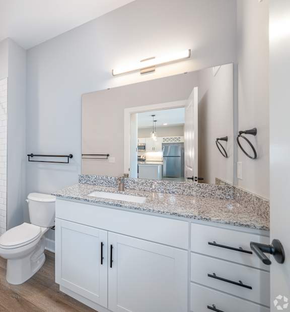 A white bathroom with a toilet, sink, and bathtub.