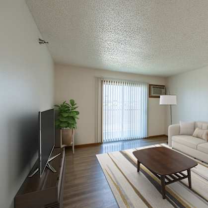 Fargo, ND Parkside Apartments. A living room with a couch, coffee table, tv, and a glass sliding door.