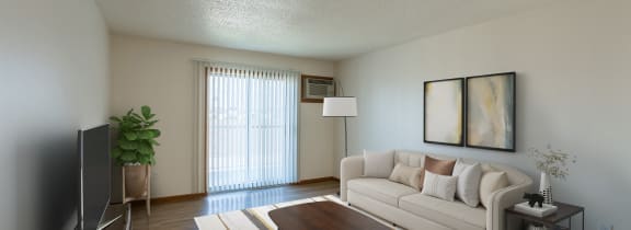 Fargo, ND Parkside Apartments. A living room with a couch, coffee table, tv, and a glass sliding door.