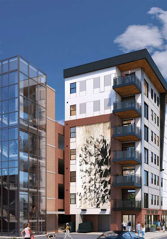 A modern building with a large mural on the side.